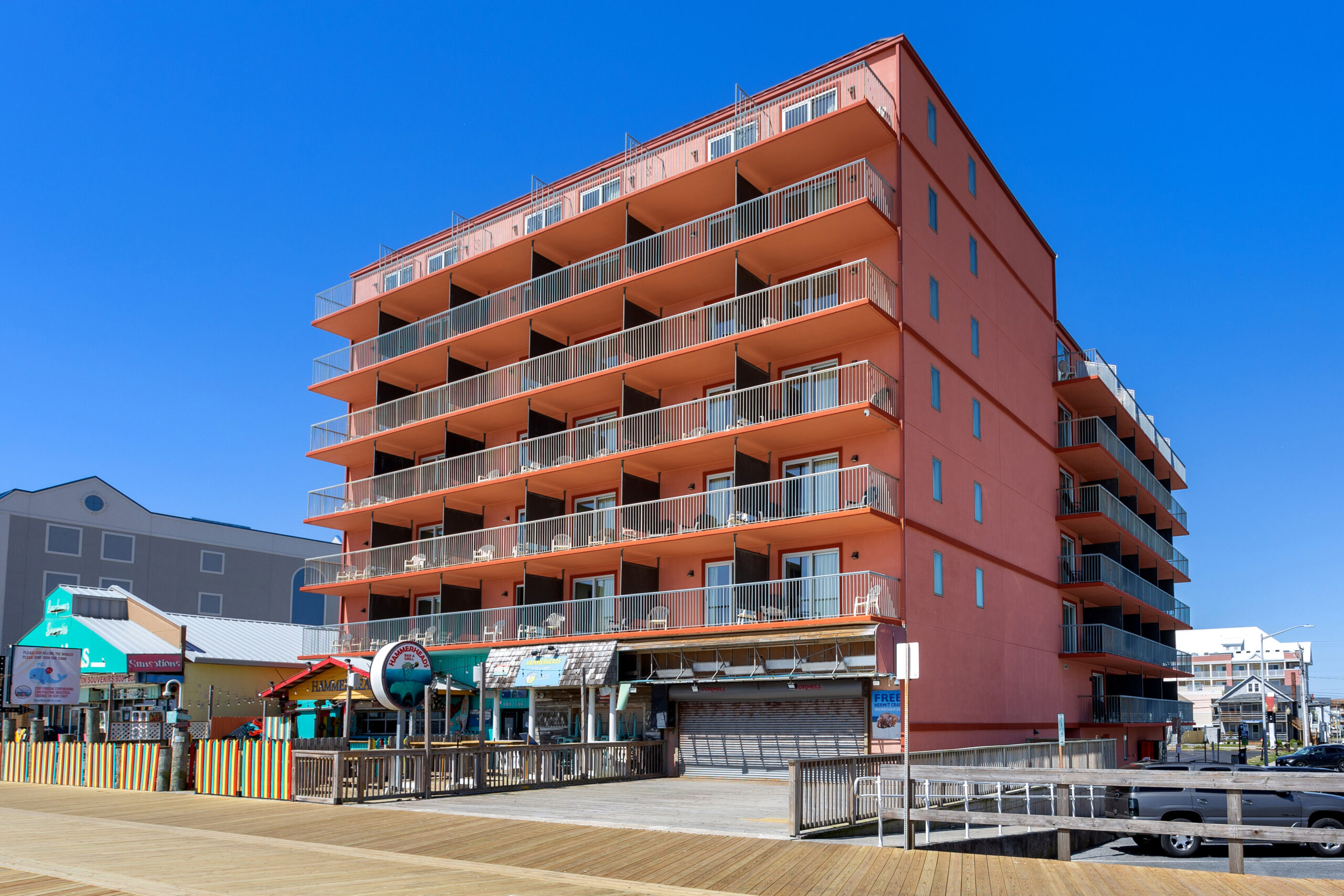 a large red building sitting on the side of a pier