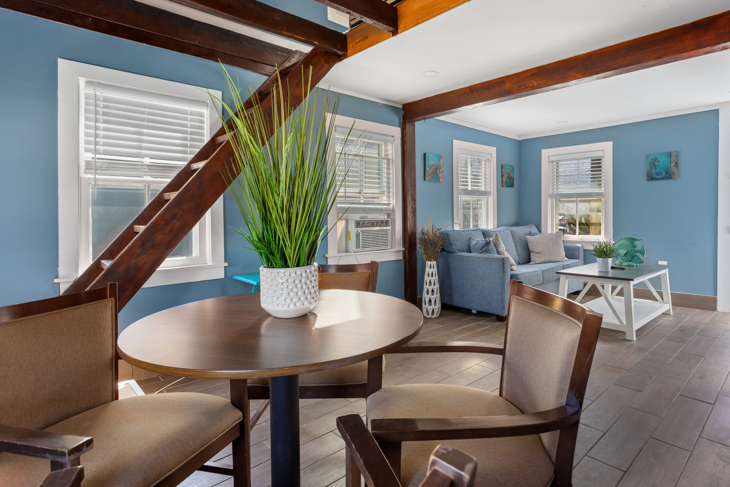 a living room with blue walls and wooden floors