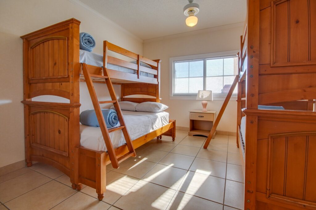 a bedroom with bunk beds and a window