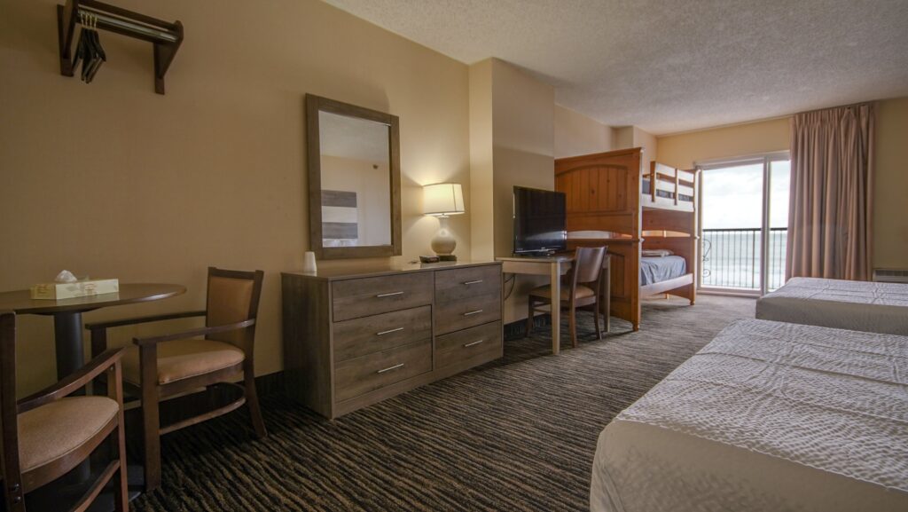 a hotel room with two beds and a desk