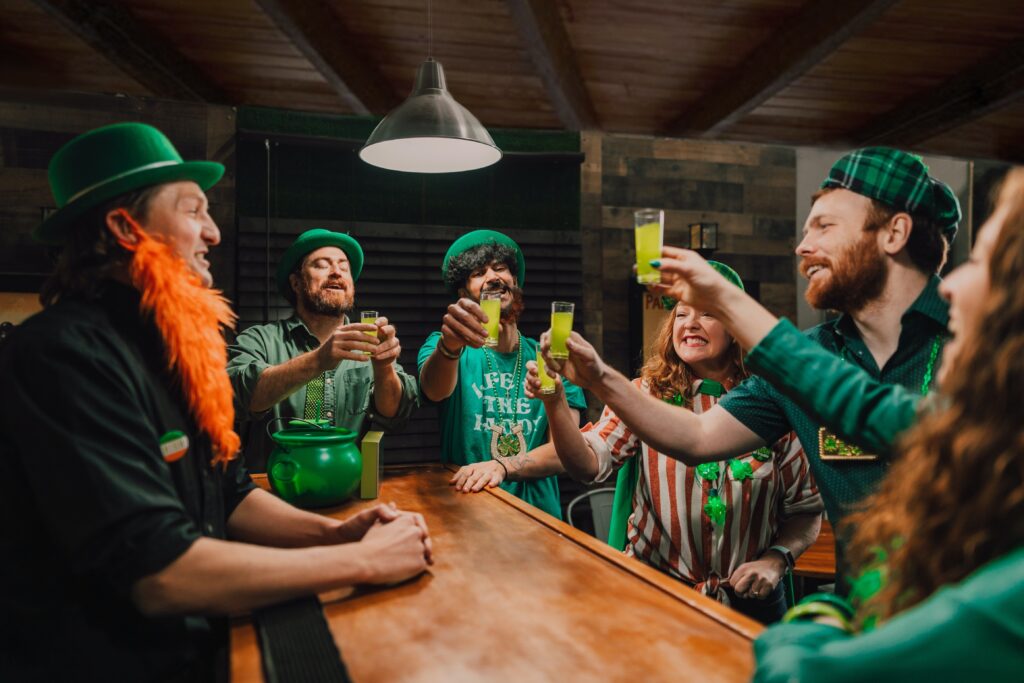 a group of people wearing green hats at a bar